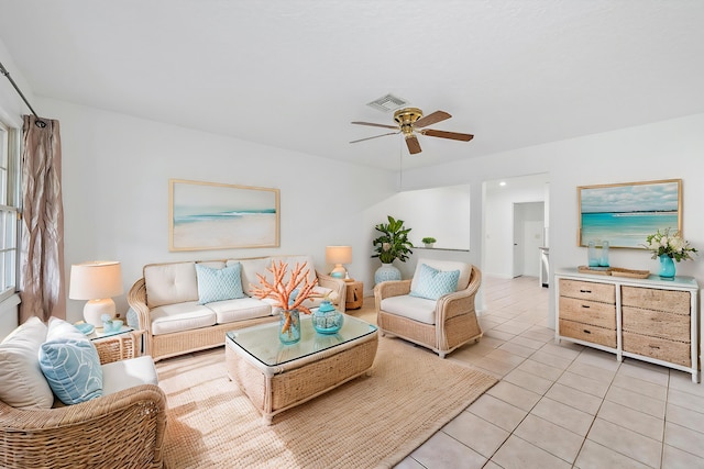 living room featuring light tile patterned floors and ceiling fan