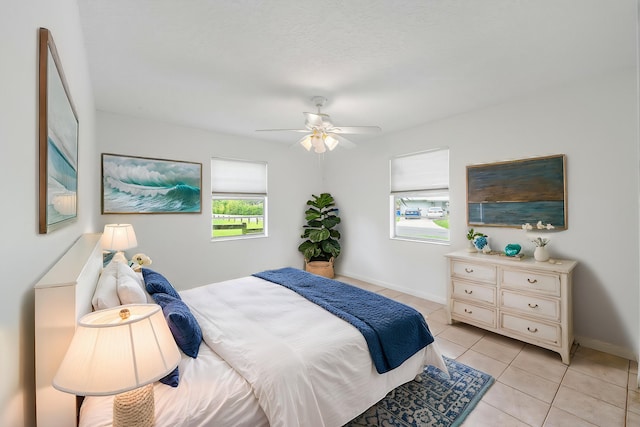 tiled bedroom featuring ceiling fan