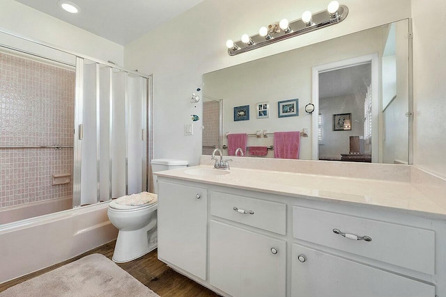 full bathroom featuring toilet, hardwood / wood-style floors, vanity, and shower / tub combo with curtain