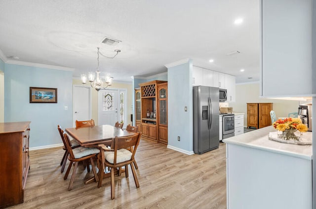 dining space with a chandelier, light hardwood / wood-style floors, and crown molding