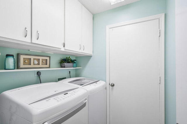 clothes washing area with washer and clothes dryer and cabinets