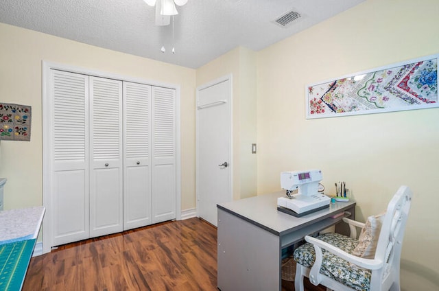 office space with dark hardwood / wood-style floors, ceiling fan, and a textured ceiling