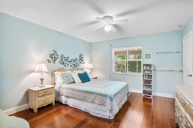 bedroom with ceiling fan, dark hardwood / wood-style flooring, and a textured ceiling