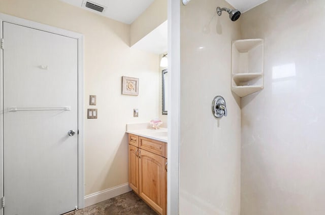 bathroom with a shower and vanity