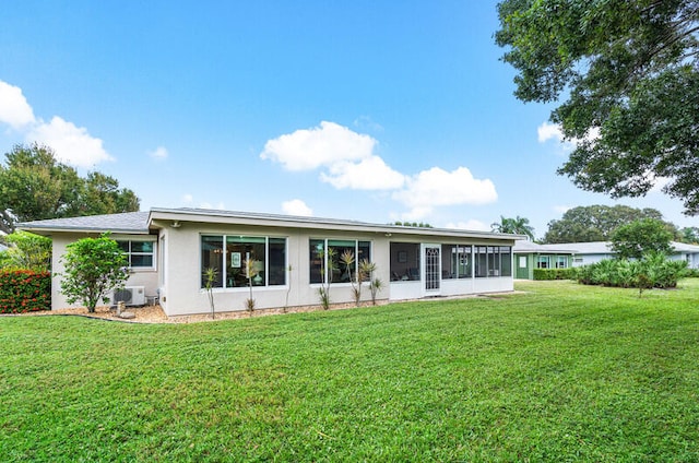 rear view of property with a yard