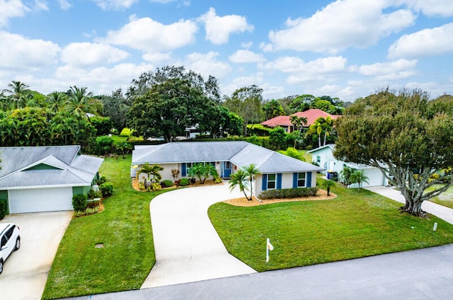 ranch-style home with a garage and a front lawn