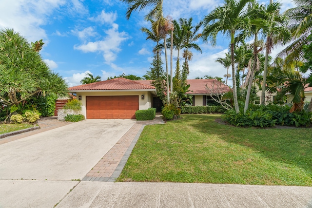 view of front of property featuring a garage and a front lawn