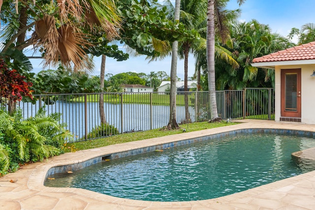 view of swimming pool featuring a water view