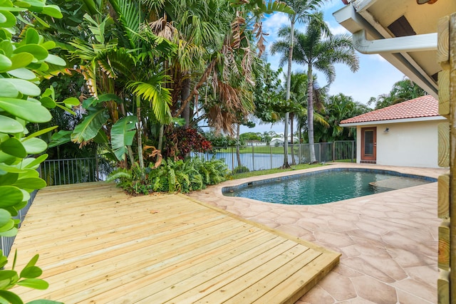 view of pool featuring a patio area and a deck with water view