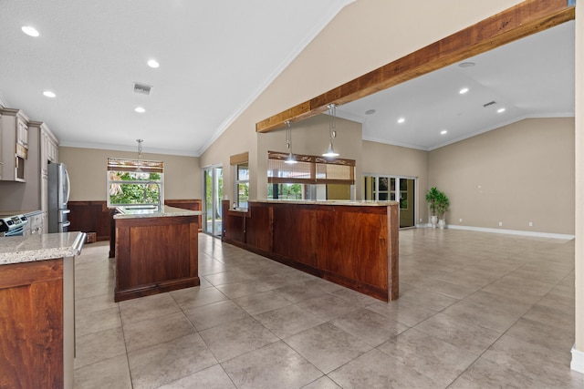 kitchen featuring decorative light fixtures, stainless steel refrigerator, vaulted ceiling, and a kitchen island