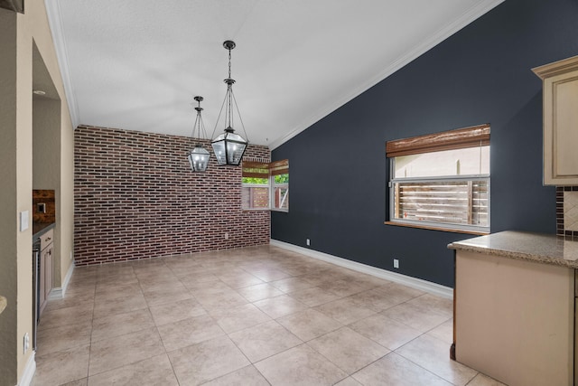 unfurnished dining area featuring brick wall, ornamental molding, light tile patterned floors, and lofted ceiling