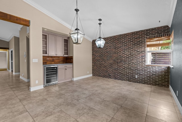 kitchen featuring hanging light fixtures, brick wall, crown molding, and wine cooler