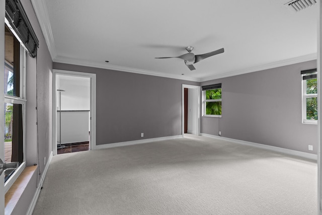 carpeted empty room with ceiling fan and ornamental molding