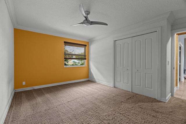 unfurnished bedroom with light colored carpet, a closet, ceiling fan, and ornamental molding