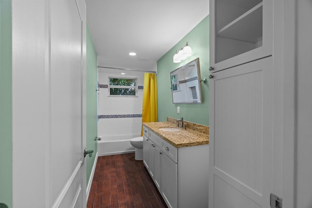 full bathroom with shower / bath combo with shower curtain, wood-type flooring, toilet, and vanity