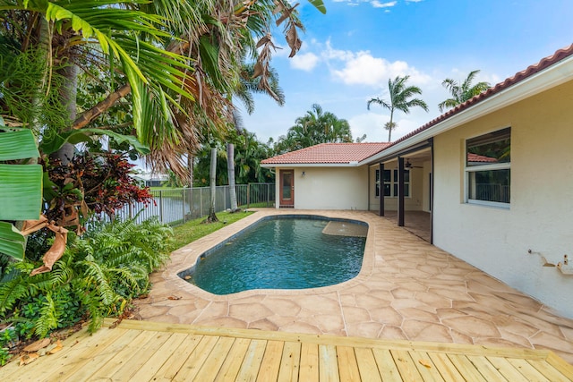 view of swimming pool featuring ceiling fan and a patio area