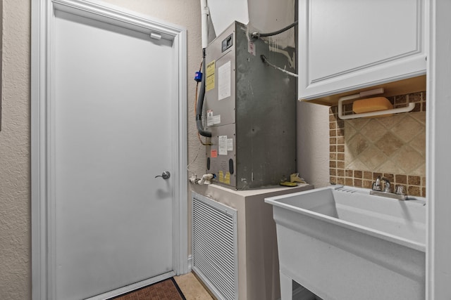 laundry room with sink and tile patterned flooring