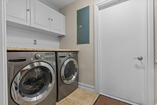 laundry area featuring cabinets, separate washer and dryer, electric panel, and light tile patterned flooring