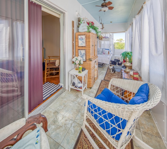 sunroom / solarium featuring ceiling fan