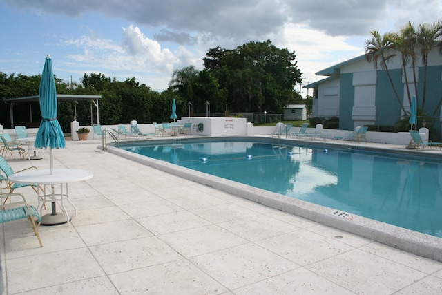 view of swimming pool with a patio