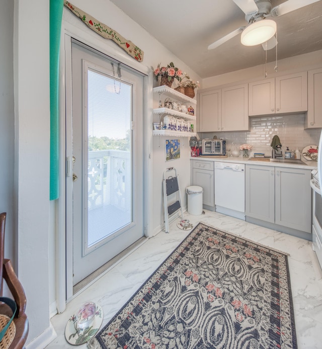 kitchen with backsplash, white dishwasher, and ceiling fan