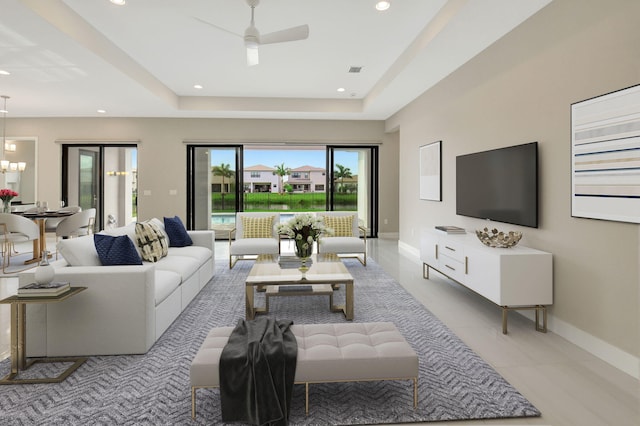 living room featuring a tray ceiling and ceiling fan