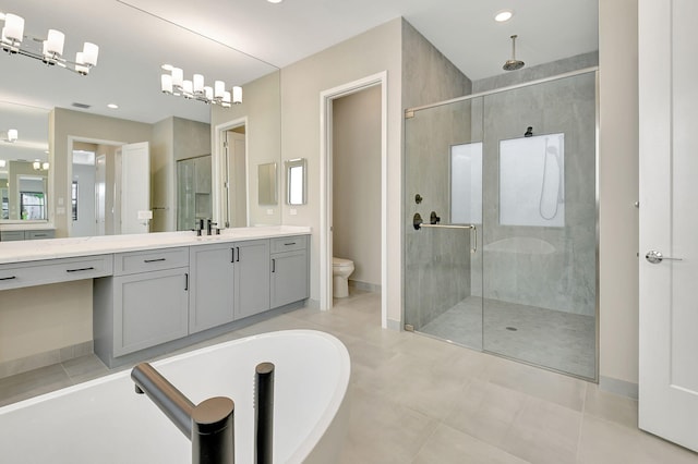 full bathroom featuring vanity, tile patterned floors, toilet, shower with separate bathtub, and a chandelier