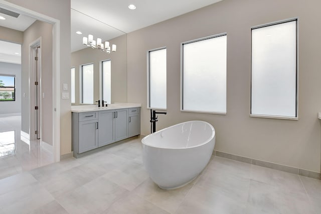 bathroom featuring a washtub, vanity, and tile patterned flooring