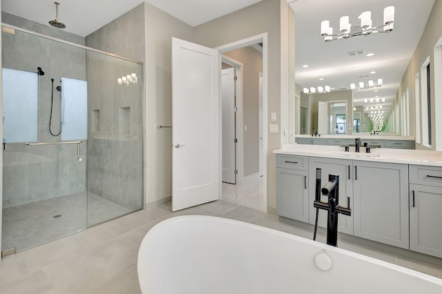 bathroom with tile patterned floors, vanity, and shower with separate bathtub