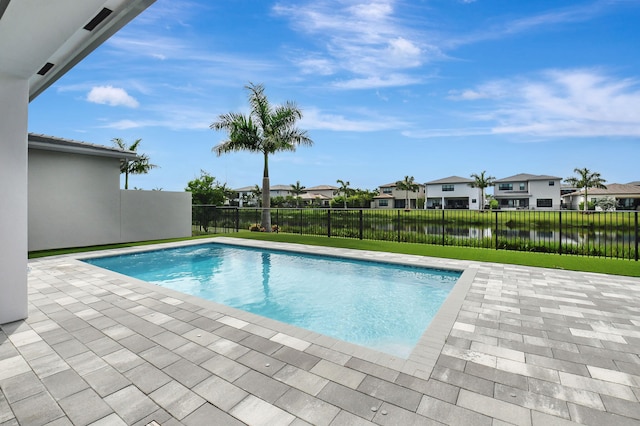 view of swimming pool with a water view and a patio area