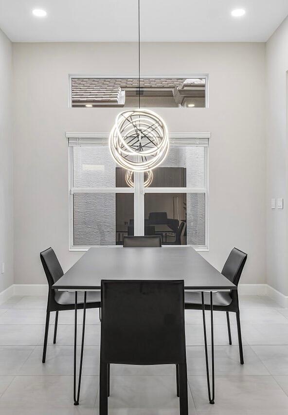 tiled dining area featuring a notable chandelier