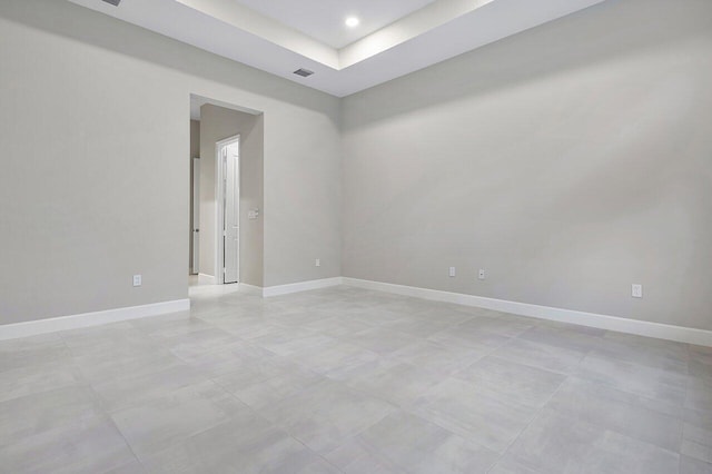 empty room featuring a raised ceiling