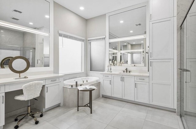 bathroom with plus walk in shower, vanity, and tile patterned floors