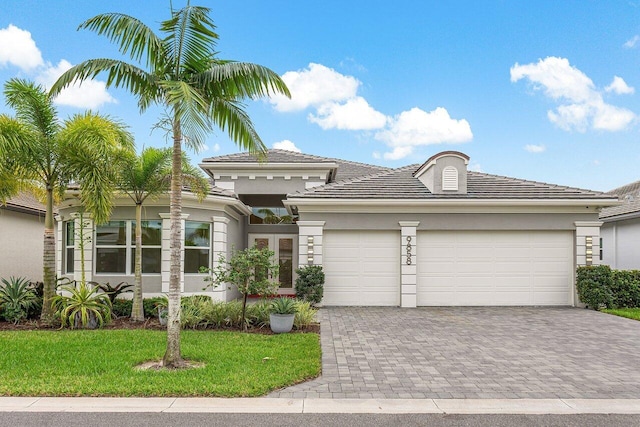 view of front of house with a front yard and a garage