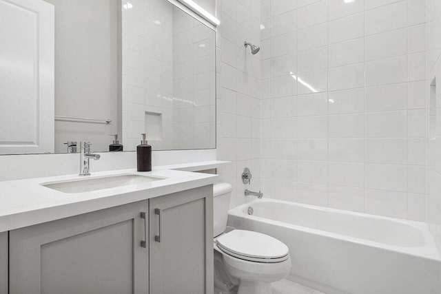 full bathroom featuring vanity, toilet, and tiled shower / bath