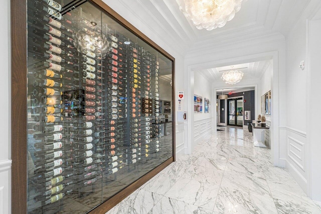 wine room featuring crown molding and a chandelier