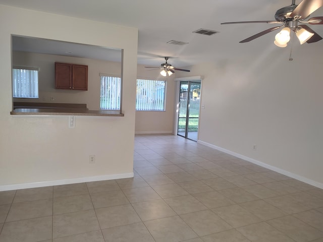 interior space with light tile patterned floors and ceiling fan