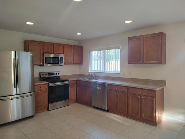 kitchen featuring sink, light tile patterned flooring, and appliances with stainless steel finishes