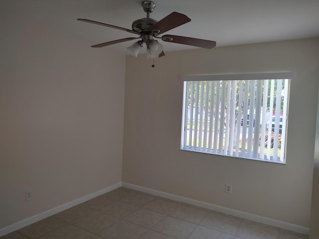 empty room featuring ceiling fan and light tile patterned flooring