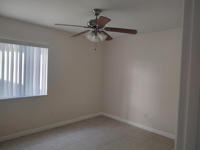 tiled spare room with ceiling fan