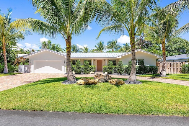 single story home with a garage and a front yard