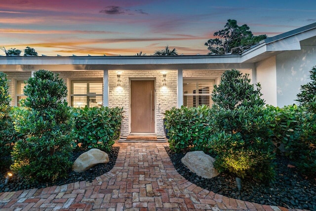 view of exterior entry at dusk