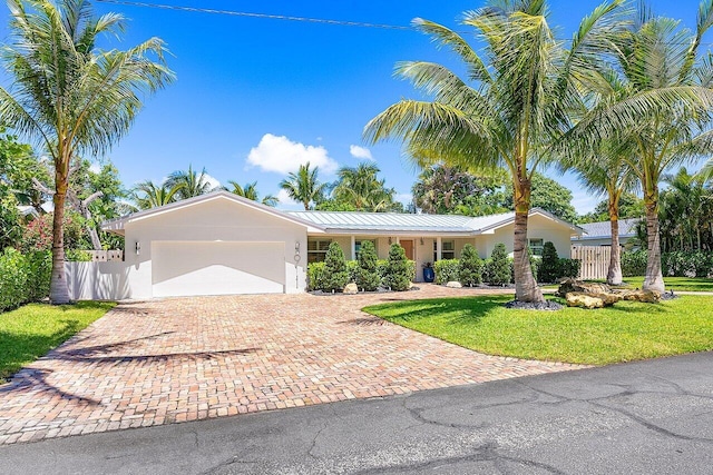 single story home featuring a front lawn and a garage