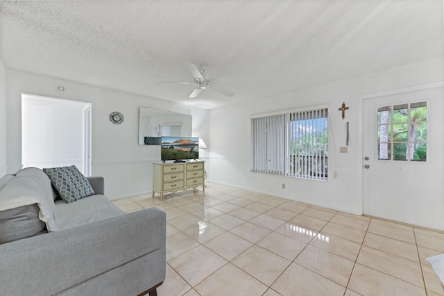 435 Pine Glen Ln Unit B-2, Greenacres, FL 33463 - tiled living room featuring ceiling fan, a textured ceiling, and baseboards