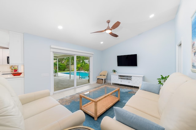 living room featuring ceiling fan and lofted ceiling