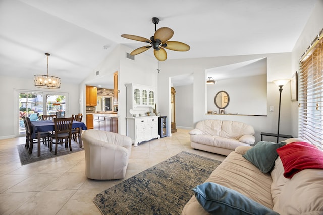 living room with ceiling fan with notable chandelier, light tile patterned floors, baseboards, and visible vents