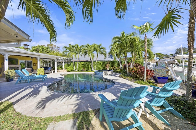 view of pool featuring ceiling fan and a patio