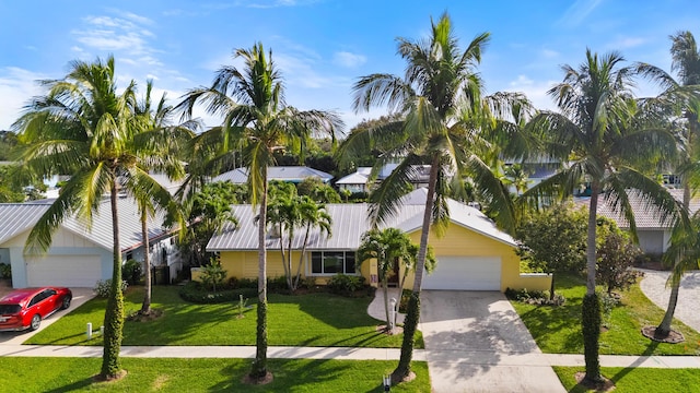 view of front of house featuring a garage and a front lawn