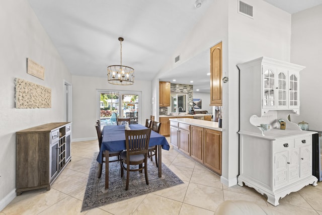 dining space featuring lofted ceiling, baseboards, and a chandelier