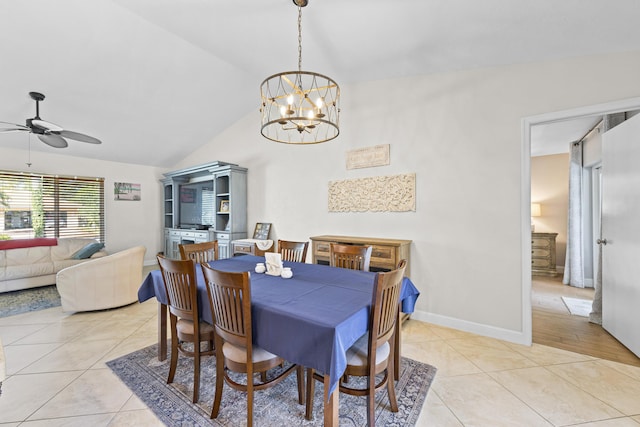 dining room featuring light tile patterned floors, baseboards, ceiling fan with notable chandelier, and vaulted ceiling